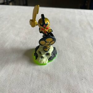 Gold and Black Action Figure on Skull Base Skylander